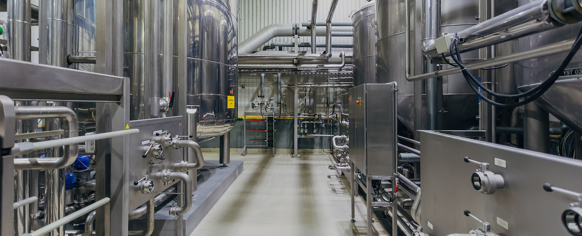 Industrial stainless steel vats in modern brewery