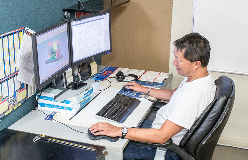 Worker in front of a computer prototyping a piece